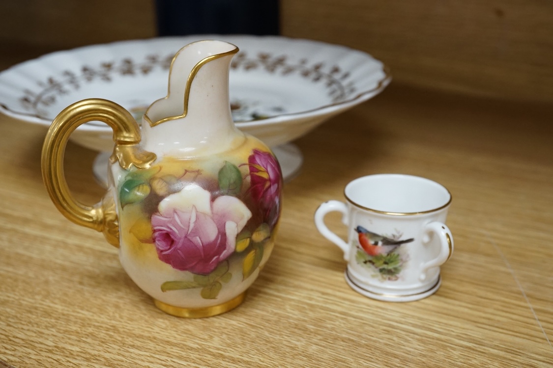 Three pieces of Worcester comprising a fruit printed and painted dish, bears signature Freeman, floral jug and a miniature tyg hand painted with a bird, largest 24cm in diameter